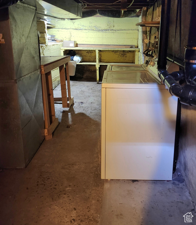 Unfinished basement with washer / clothes dryer and heating unit
