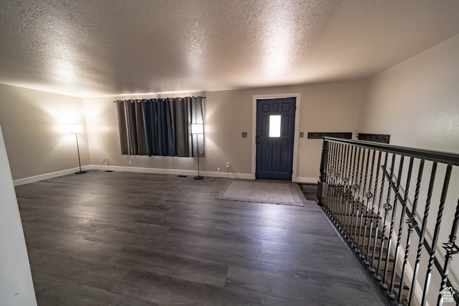 Entrance foyer featuring a textured ceiling and wood finished floors
