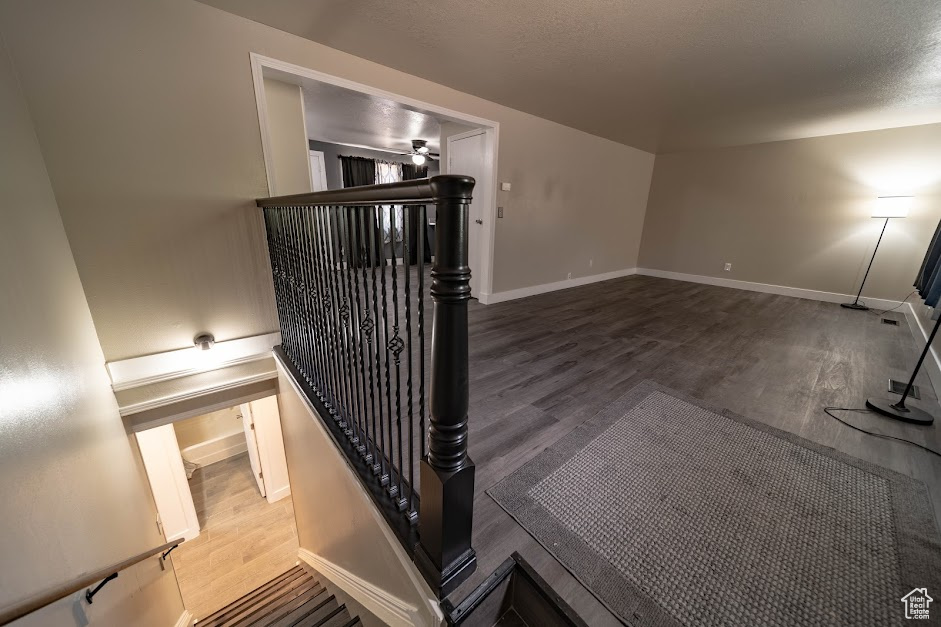 Stairway featuring wood finished floors and baseboards