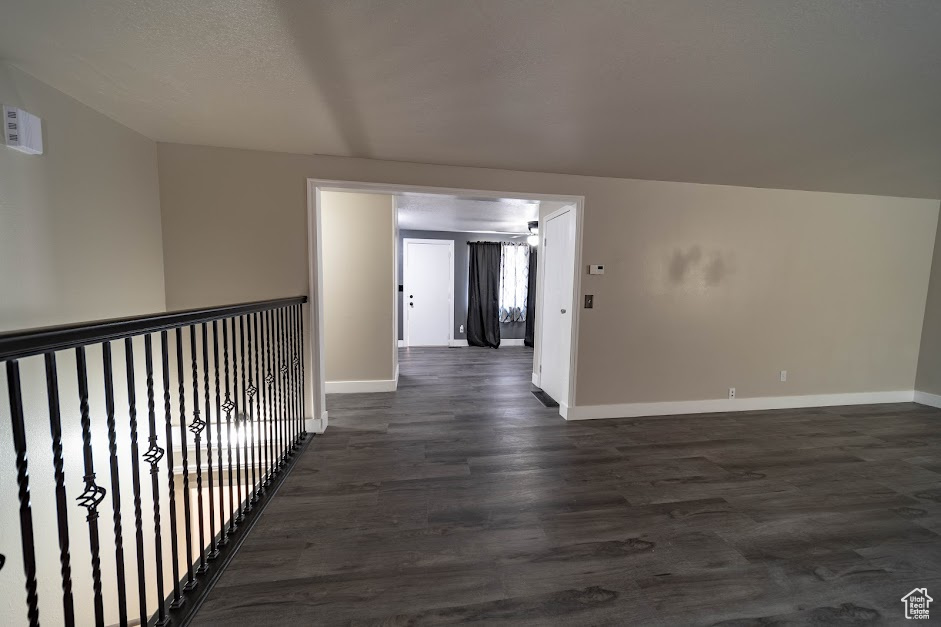 Corridor with baseboards and dark wood-style floors