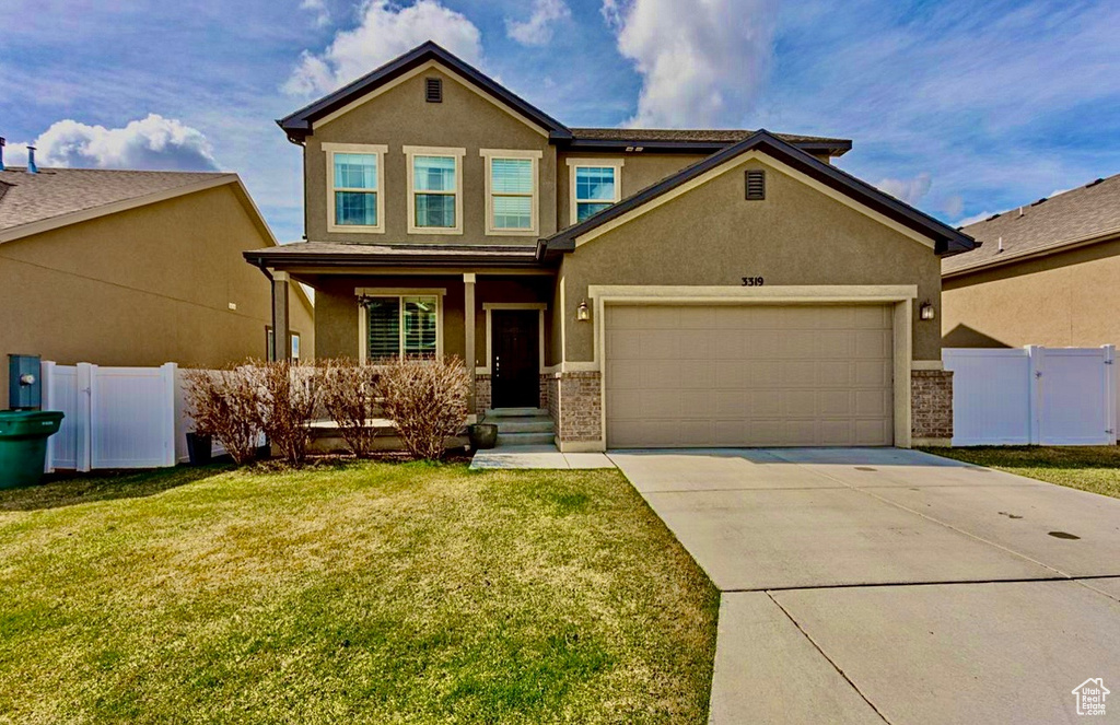 View of front of house featuring stucco siding, an attached garage, and driveway