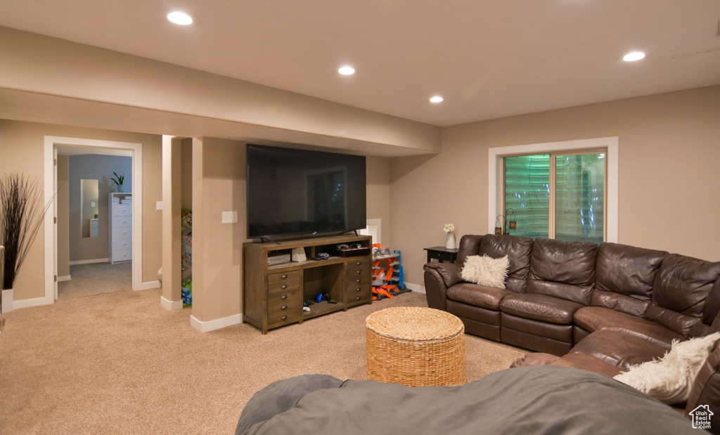 Carpeted living room featuring recessed lighting and baseboards