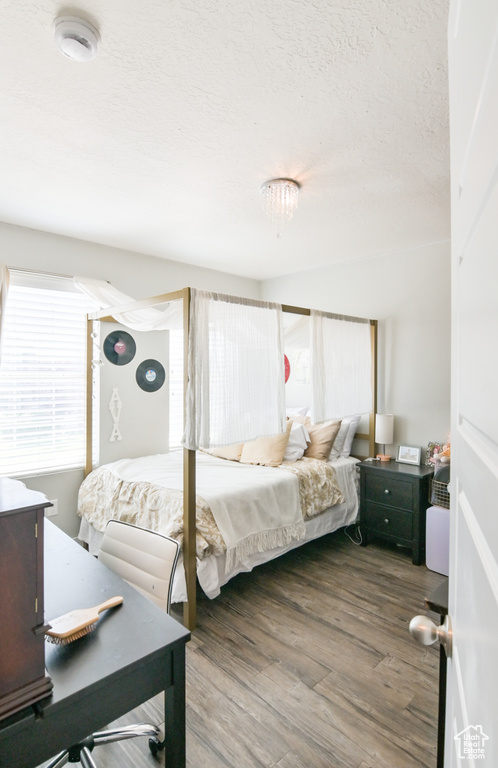 Bedroom featuring wood finished floors and a textured ceiling
