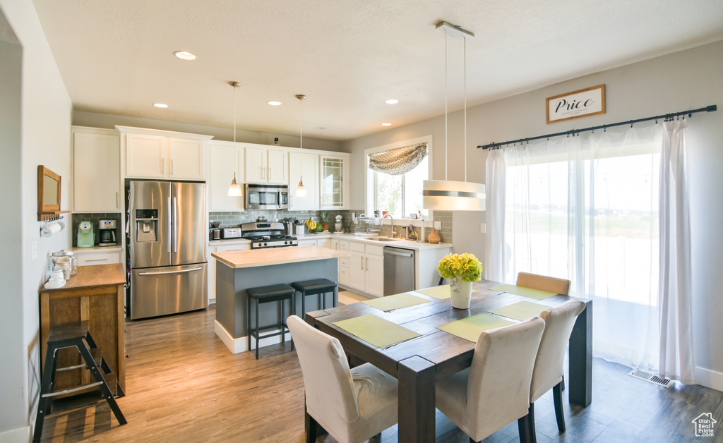 Dining area featuring light wood finished floors and recessed lighting
