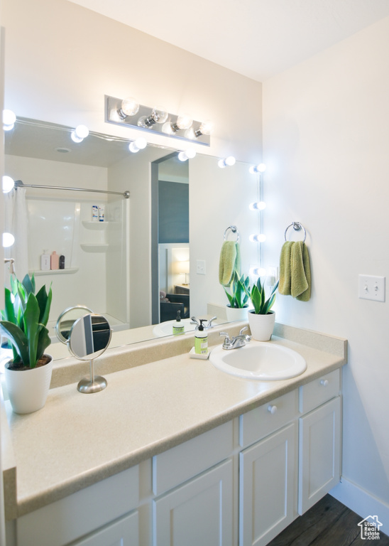 Full bath with a shower with shower curtain and vanity