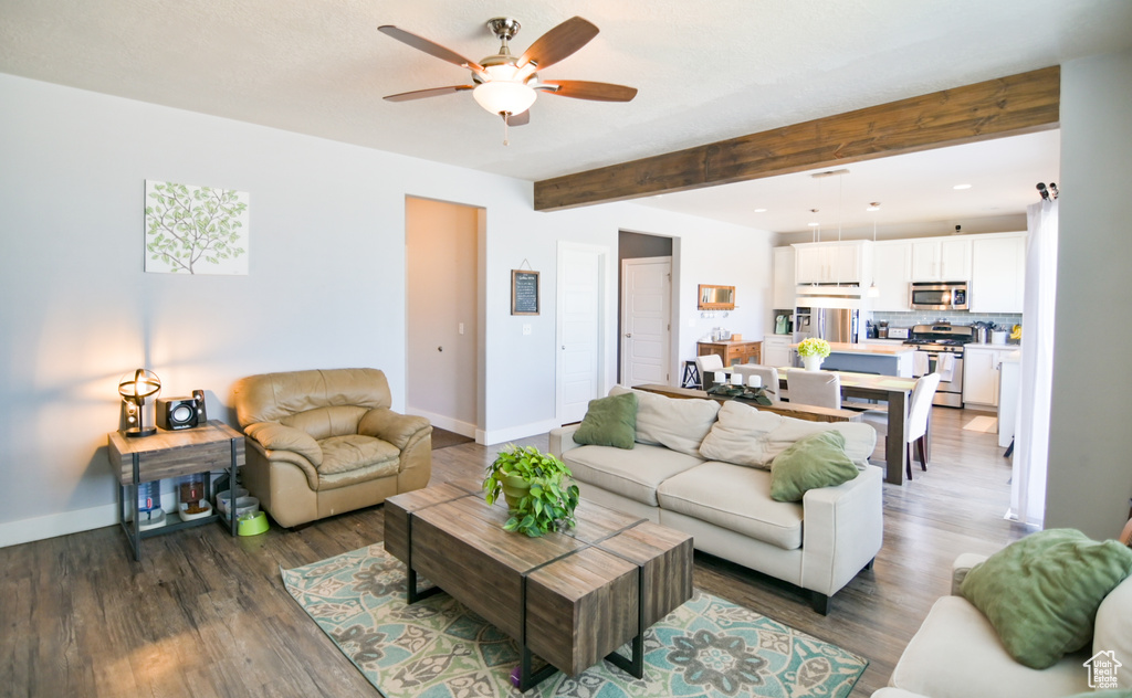 Living room with a ceiling fan, beam ceiling, wood finished floors, and recessed lighting