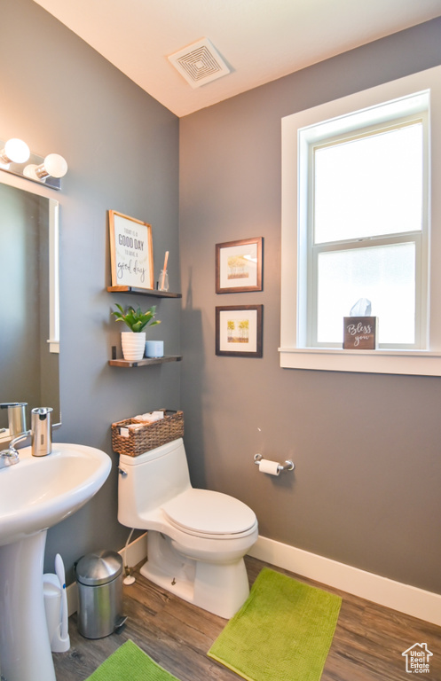 Half bathroom with wood finished floors