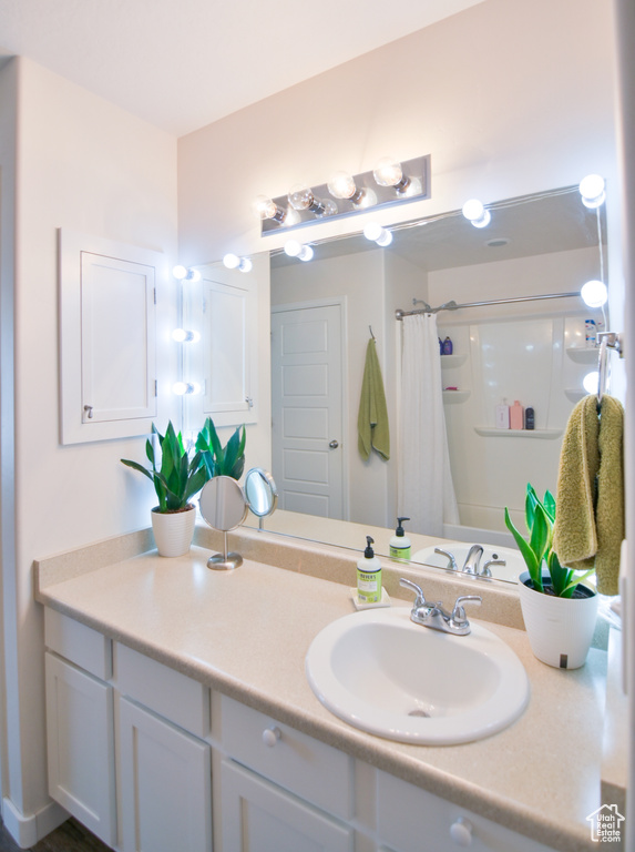 Bathroom with vanity and a shower with shower curtain