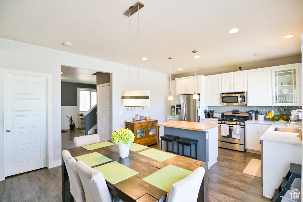 Dining room featuring dark wood finished floors and recessed lighting
