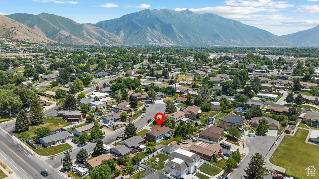 Aerial overview of property's location with a mountain backdrop and nearby suburban area