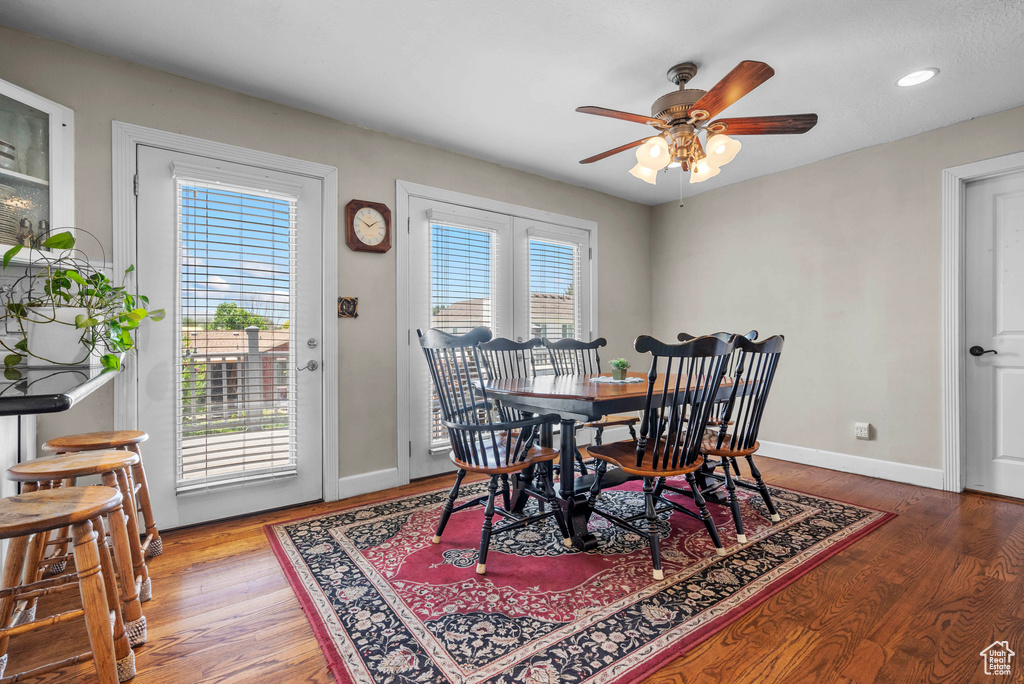 Dining space with a ceiling fan, wood finished floors, and recessed lighting