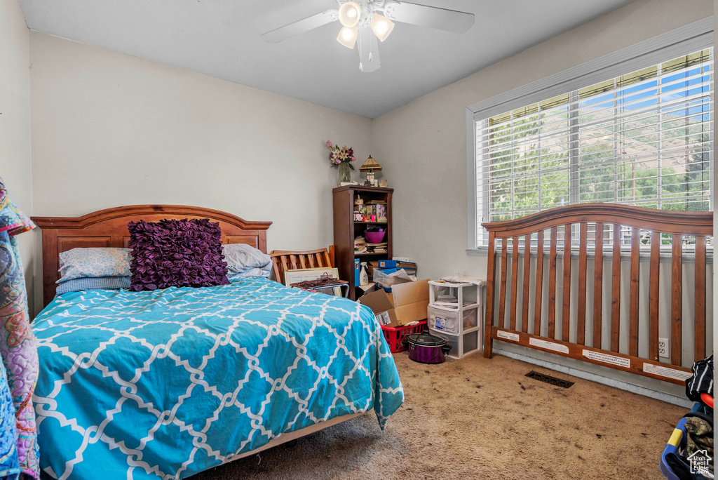 Bedroom with carpet flooring and a ceiling fan