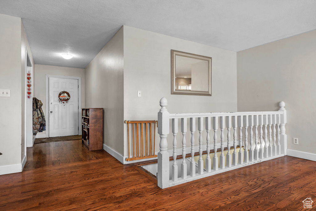 Corridor featuring wood finished floors and an upstairs landing