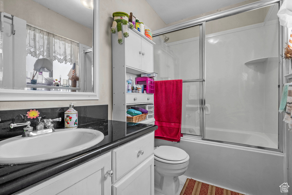 Full bathroom with vanity, combined bath / shower with glass door, and tile patterned floors