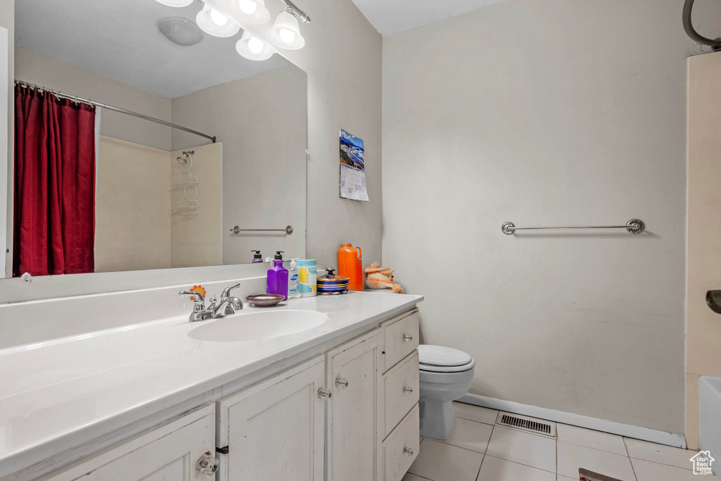 Bathroom featuring tile patterned floors and vanity