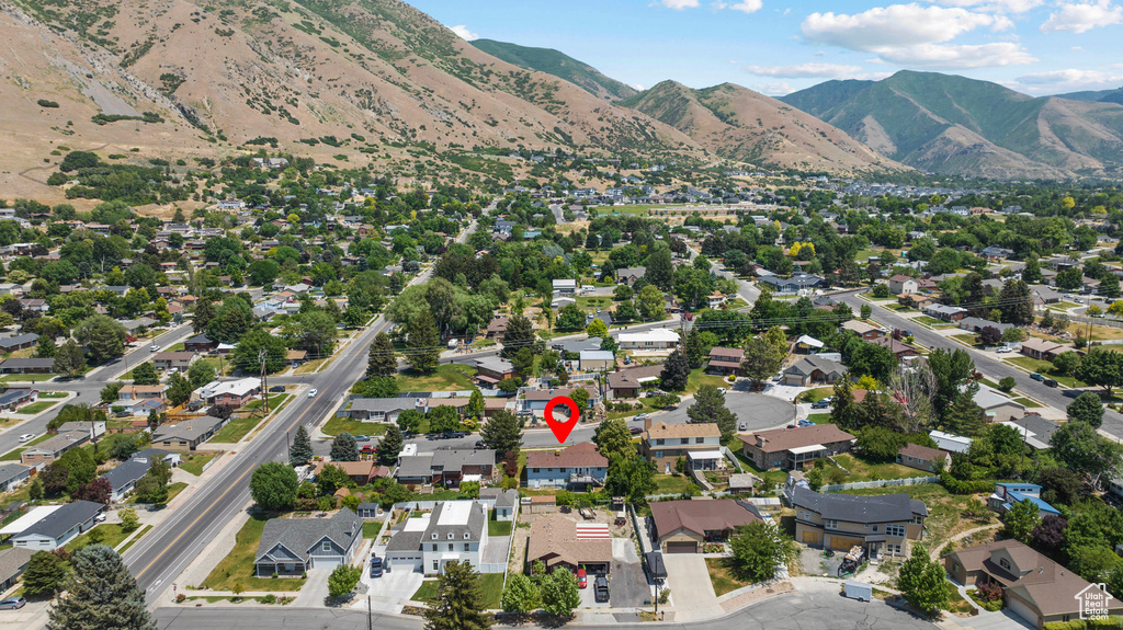 Aerial view of property's location featuring nearby suburban area and a mountainous background