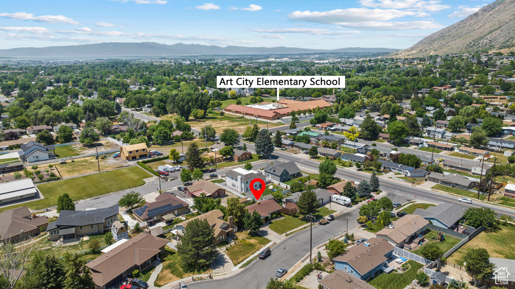 Aerial perspective of suburban area featuring a mountain backdrop