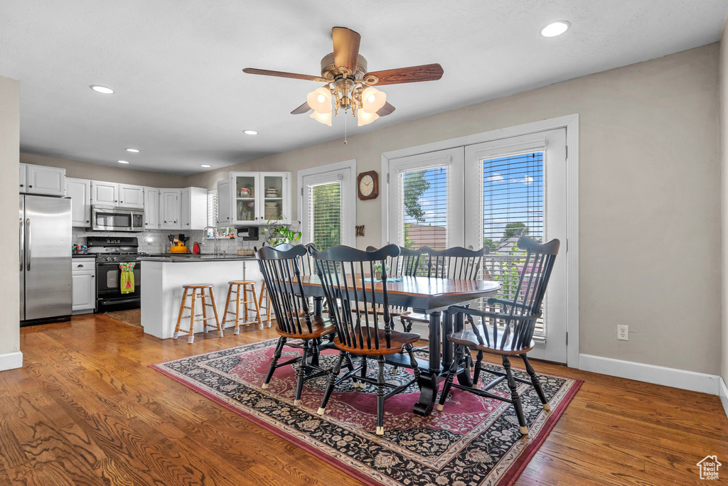 Dining room featuring ceiling fan, wood finished floors, and recessed lighting