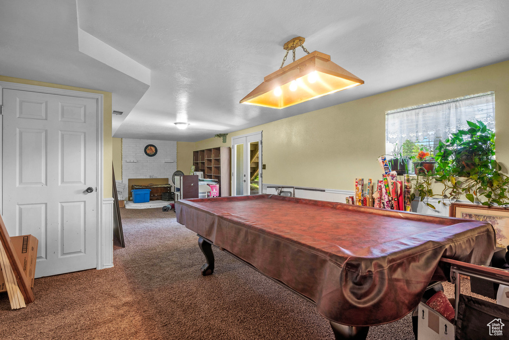 Rec room featuring carpet, pool table, and a fireplace