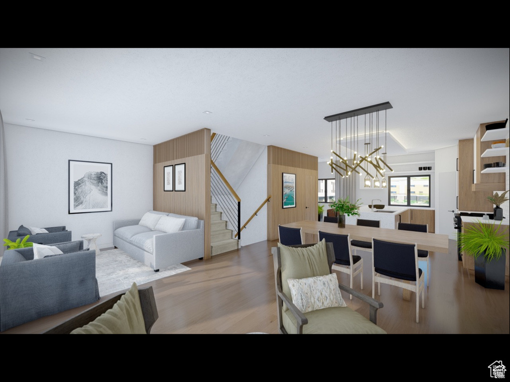 Dining space with a chandelier, stairway, and light wood finished floors