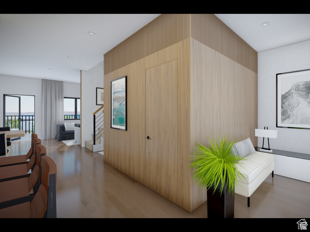 Hall with light wood-style floors and stairs