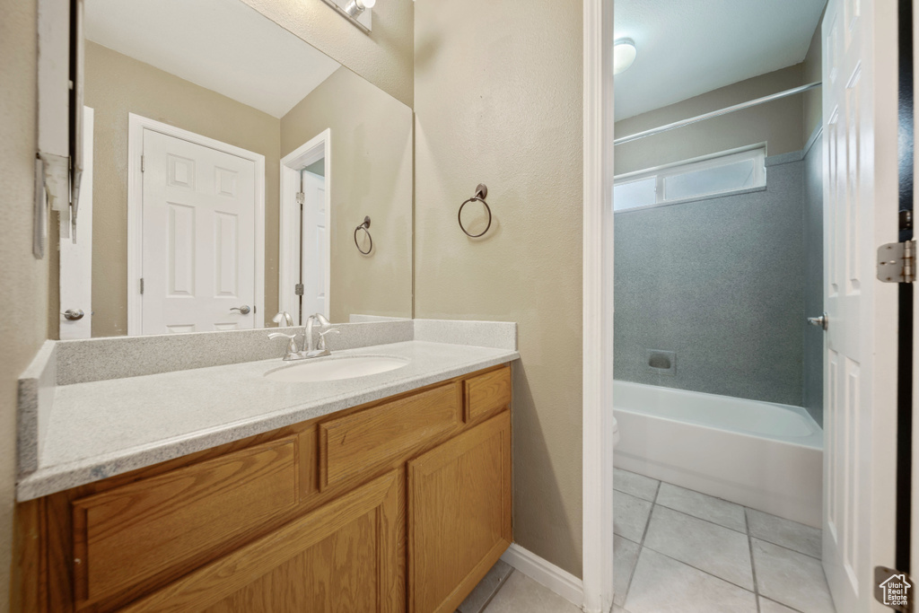Bathroom with vanity, bathing tub / shower combination, and tile patterned floors