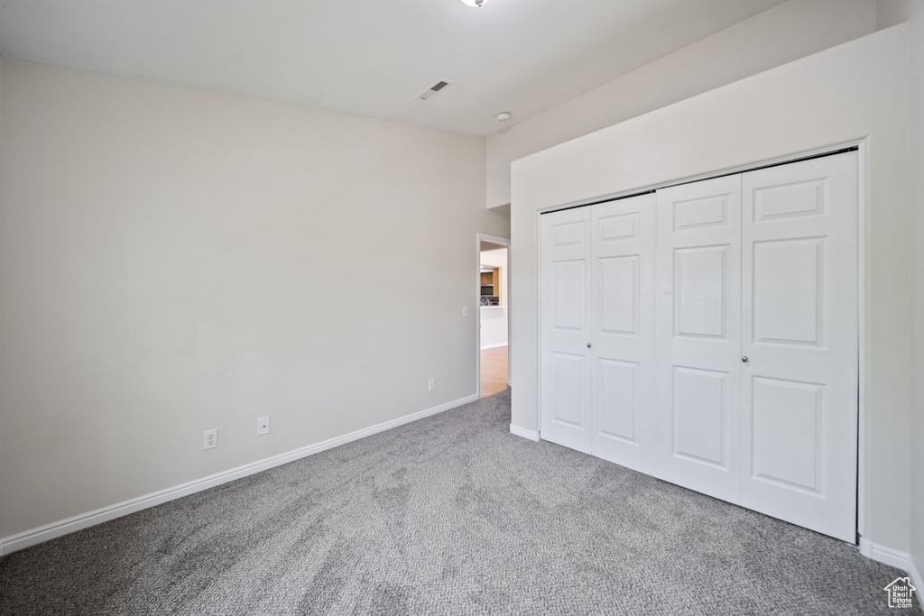 Unfurnished bedroom with carpet floors and a closet