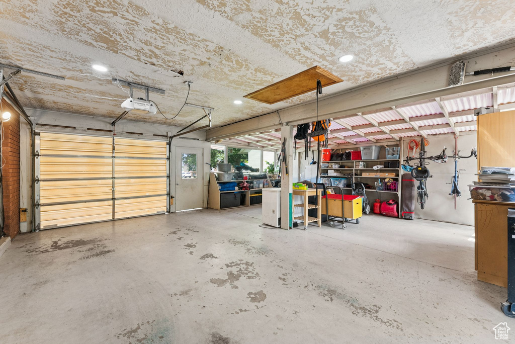 Garage with a garage door opener and recessed lighting