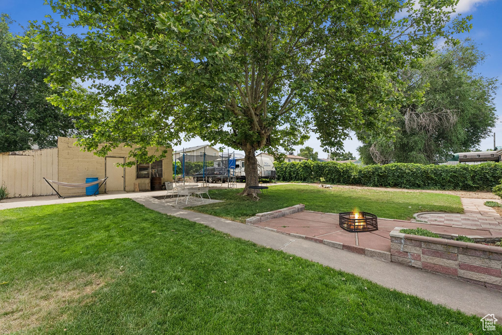 View of yard featuring a fire pit and a patio area