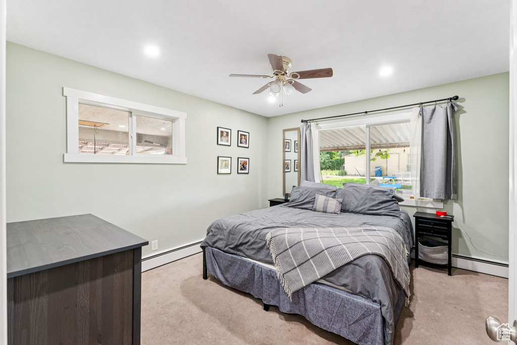 Bedroom featuring carpet flooring, a baseboard heating unit, recessed lighting, and a ceiling fan