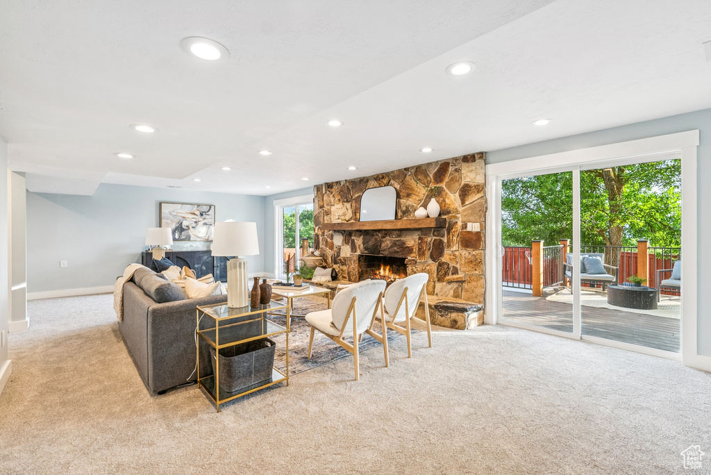 Carpeted living room with a fireplace and recessed lighting