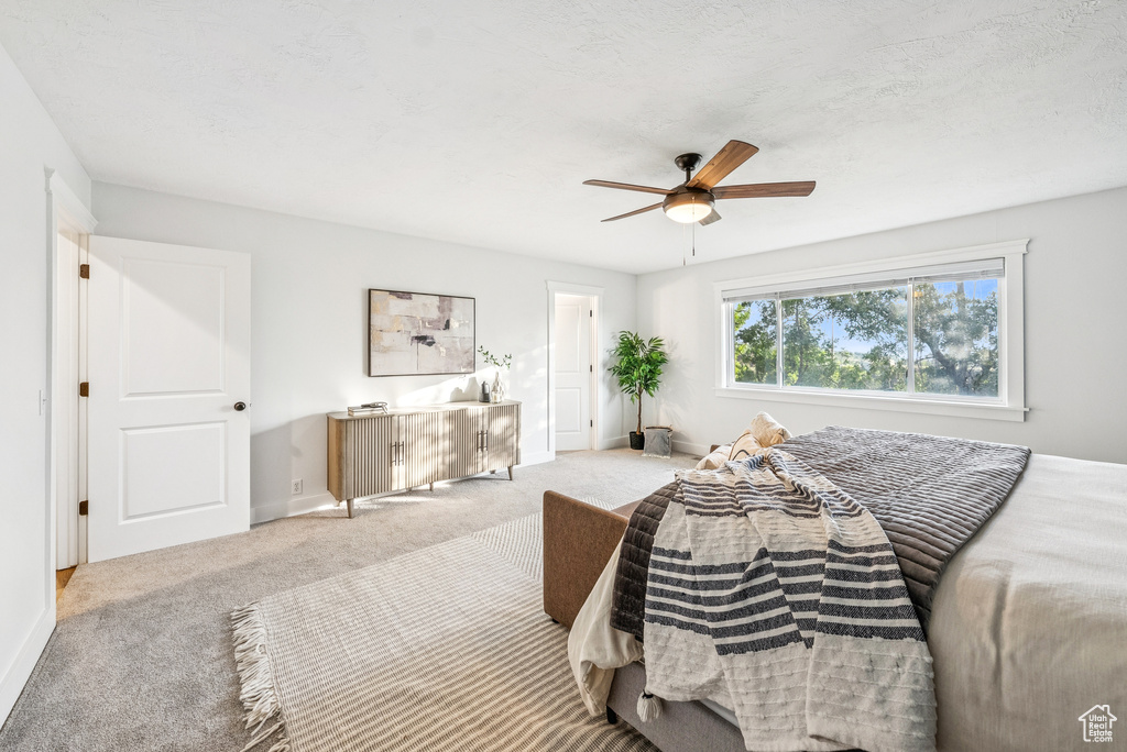 Bedroom with carpet flooring and a ceiling fan