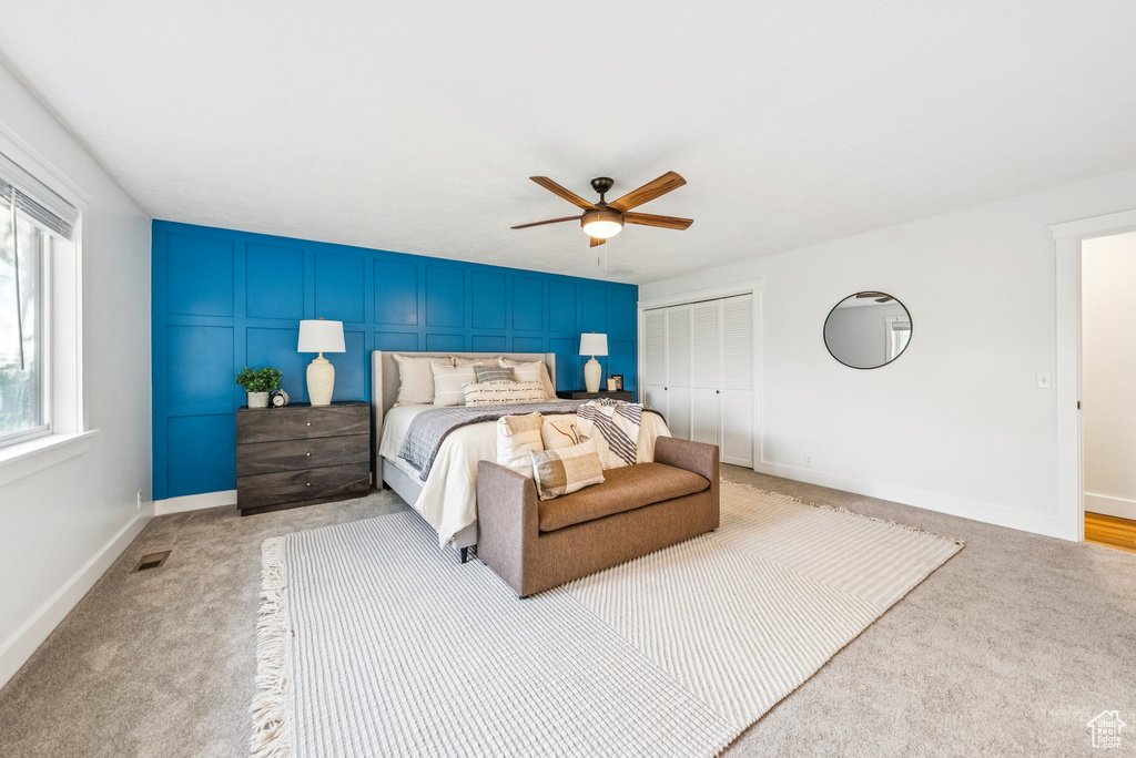 Bedroom featuring carpet flooring, a closet, and a ceiling fan