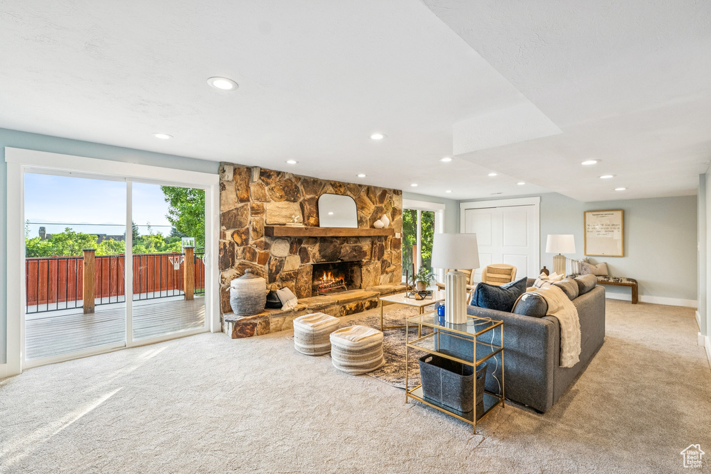Living room featuring carpet flooring, recessed lighting, and a fireplace
