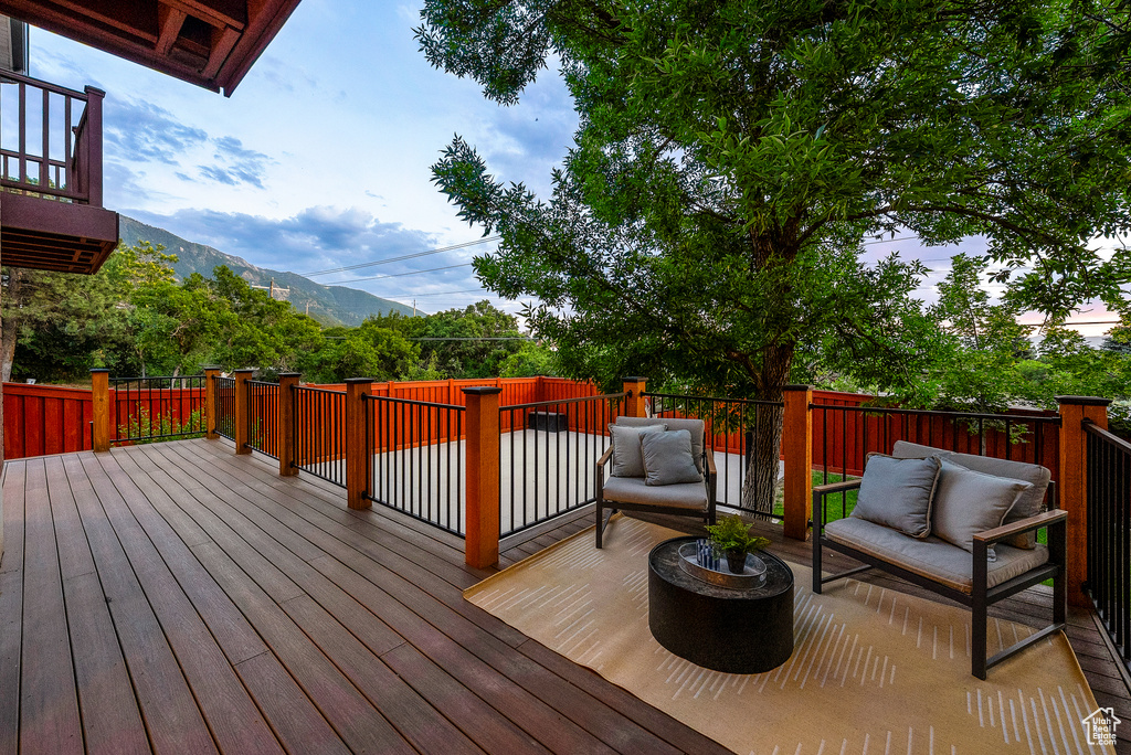 Wooden terrace featuring an outdoor hangout area and a mountain view