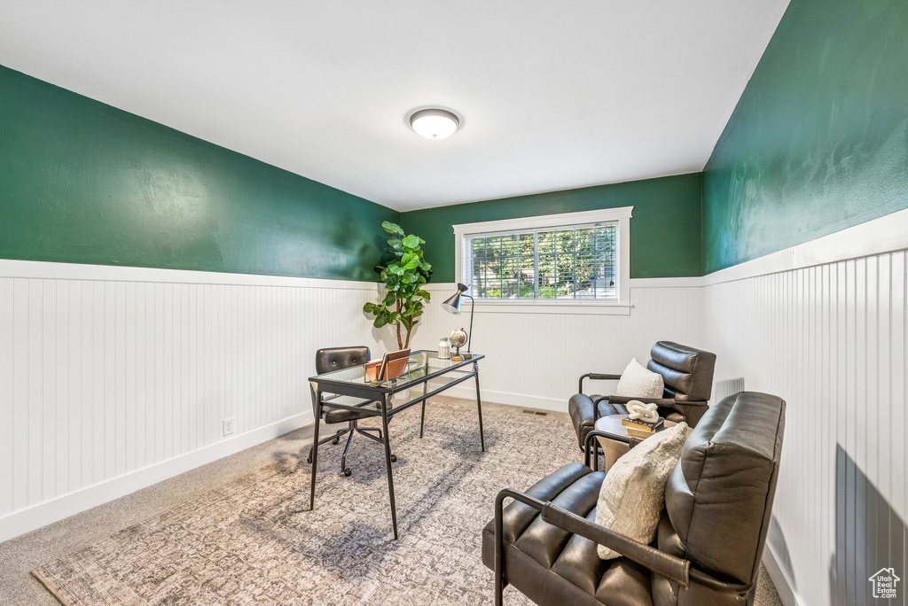Carpeted office featuring a wainscoted wall