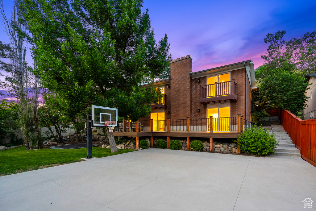 View of basketball court with a yard