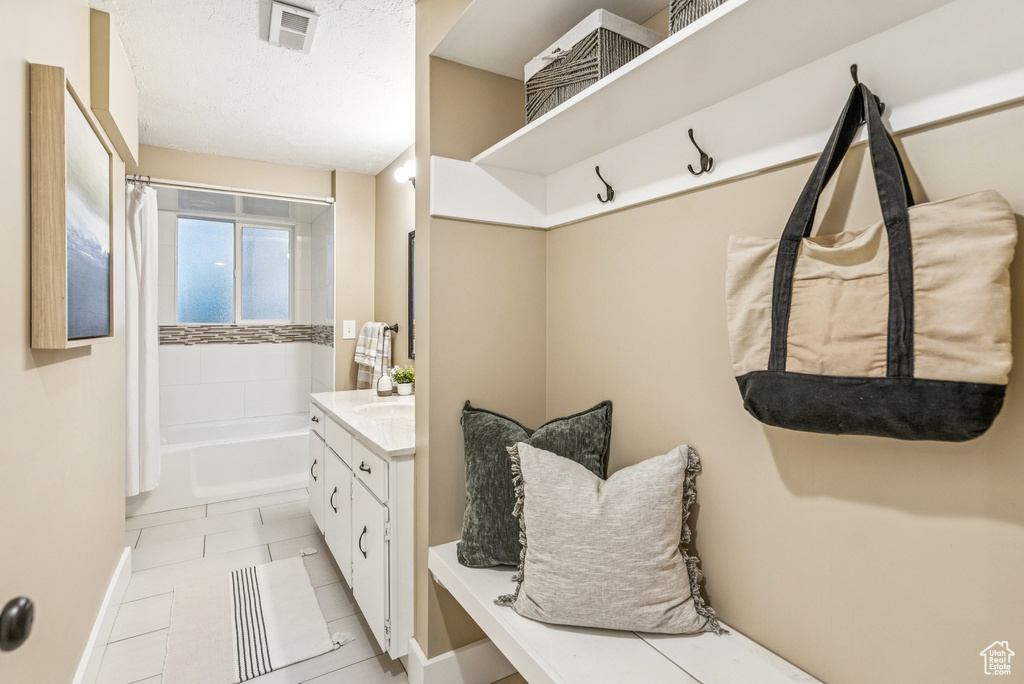 Mudroom featuring baseboards and light tile patterned floors