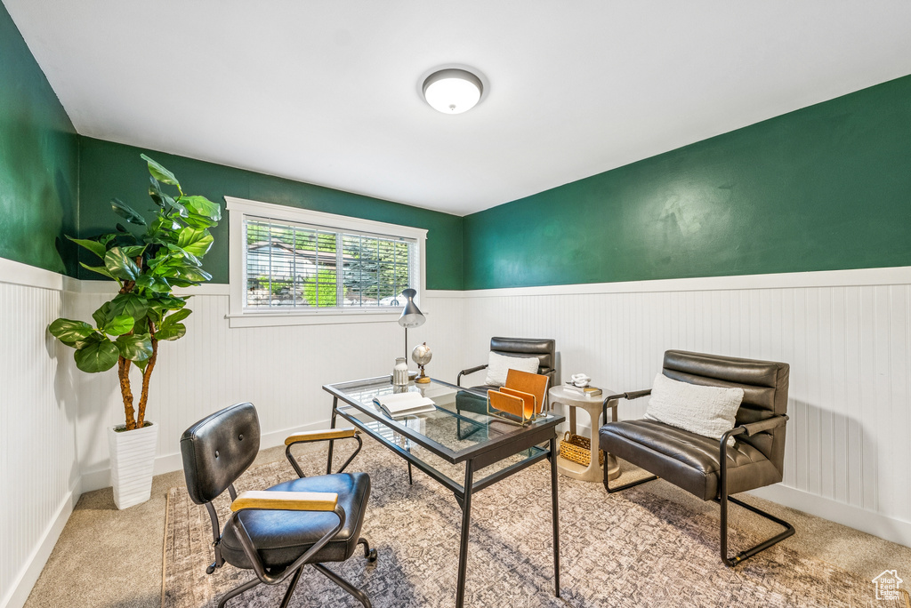 Carpeted office space with a wainscoted wall