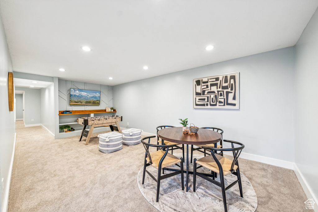 Carpeted dining space featuring recessed lighting