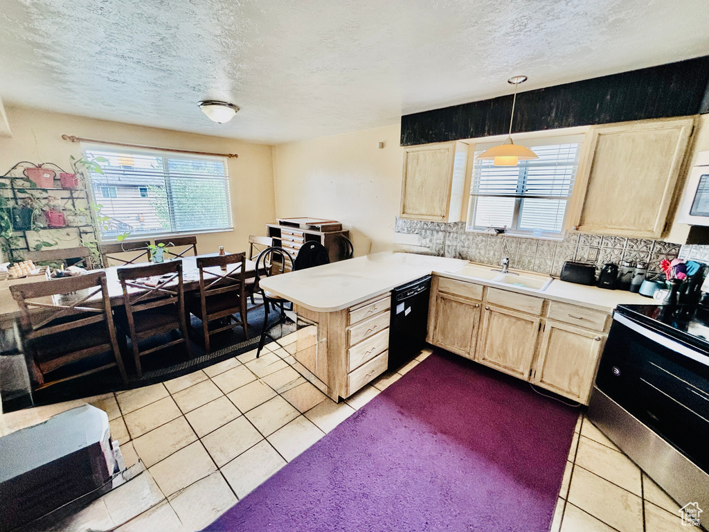 Kitchen with light brown cabinetry, stainless steel electric range oven, tile patterned flooring, a textured ceiling, and dishwasher