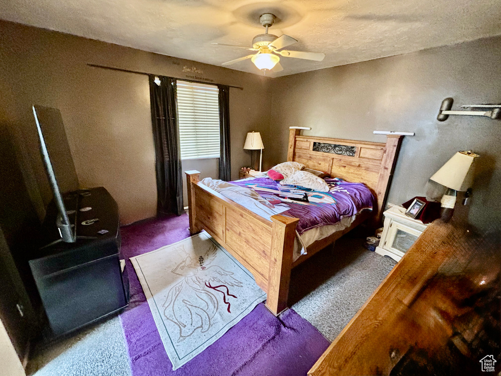 Carpeted bedroom featuring a ceiling fan