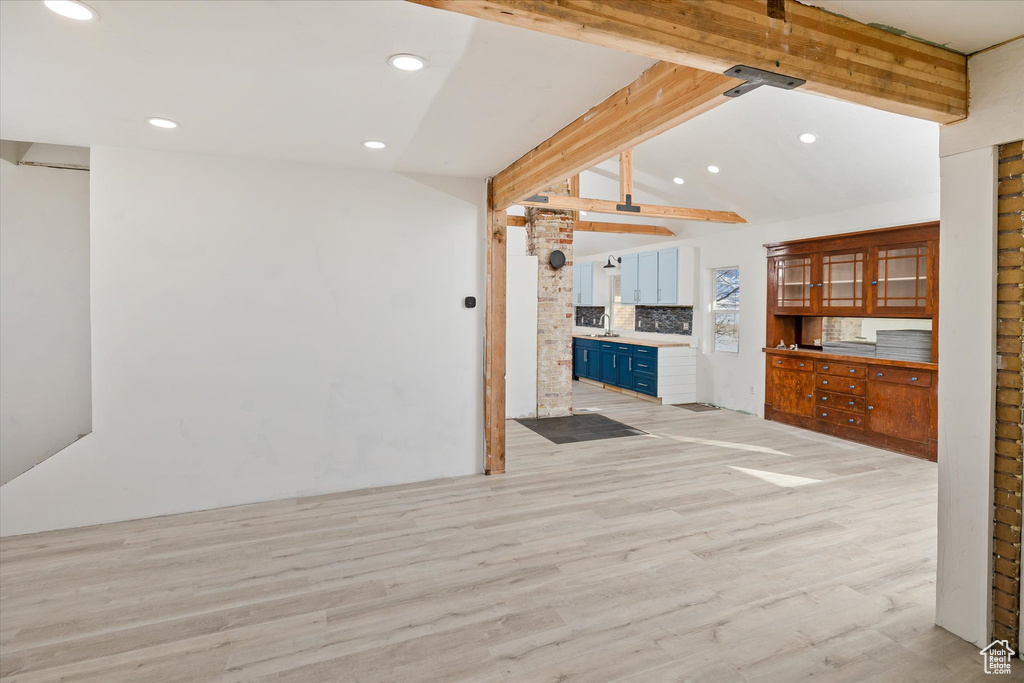 Unfurnished living room with light wood-type flooring and recessed lighting