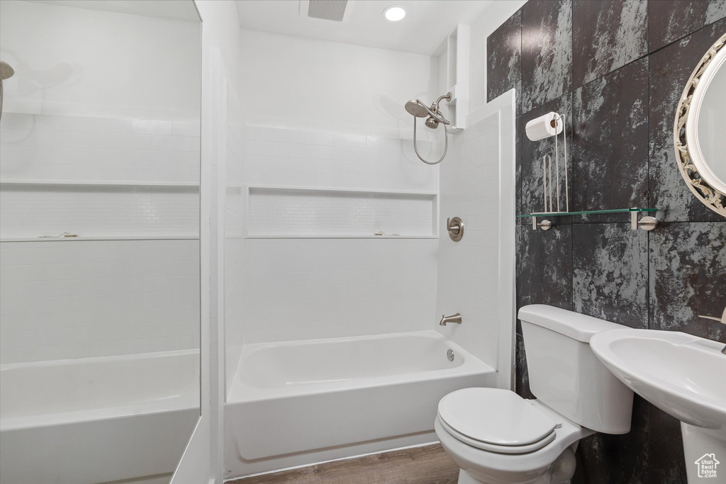 Full bath with  shower combination and wood finished floors
