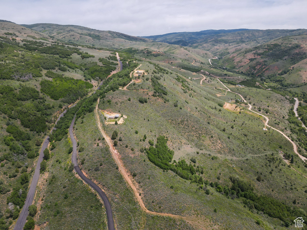 Aerial view of property and surrounding area with mountains