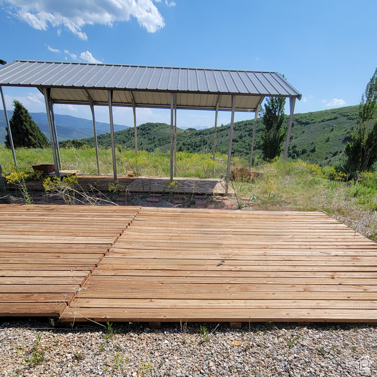 Wooden terrace featuring a mountain view