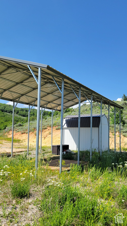View of car parking featuring a storage unit