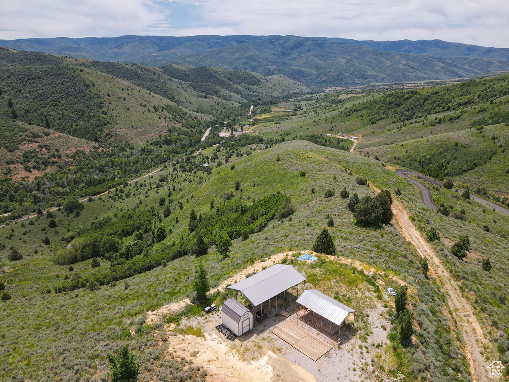 Aerial view of property and surrounding area featuring mountains