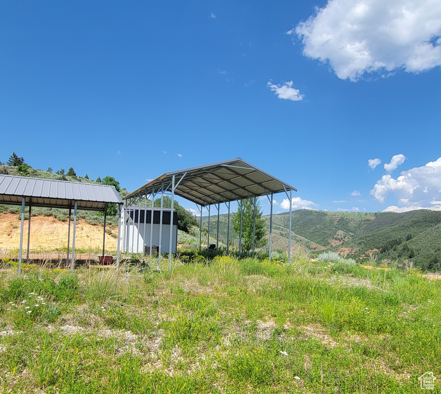 View of yard with a detached carport and a mountain view