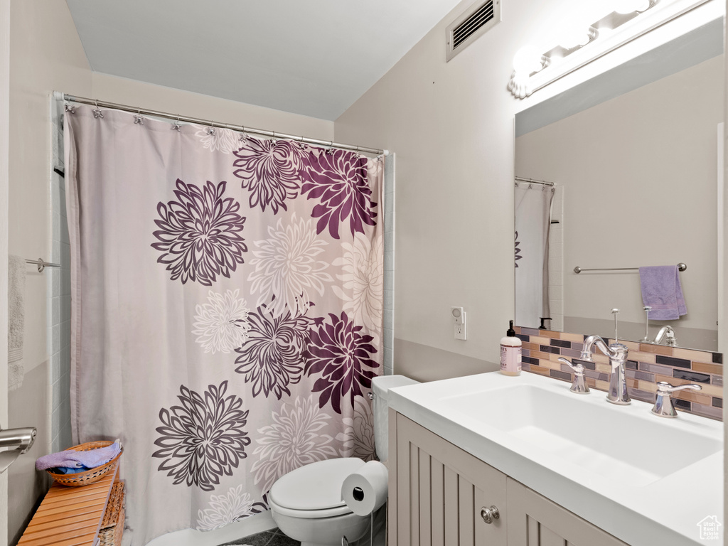 Bathroom with vanity, tasteful backsplash, and a shower with shower curtain